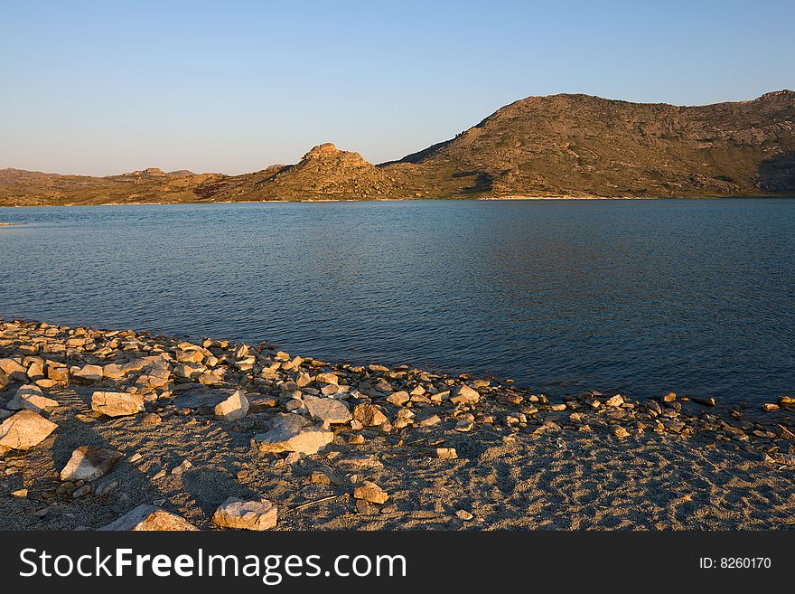 Lake and mountains landscape with blue sky