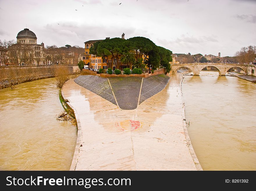 View across the River Tiber to Isola Tiberina in Rome. The island was modeled to resemble a ship by the romans in the 2nd century BC. View across the River Tiber to Isola Tiberina in Rome. The island was modeled to resemble a ship by the romans in the 2nd century BC