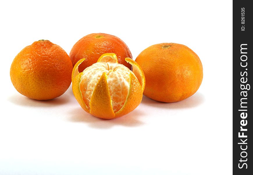 Four orange tangerines isolated on a white background