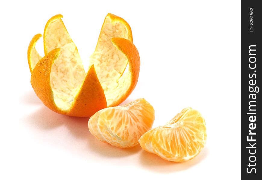 Tangerine peel cut out in the form of a crown and a tangerine segments isolated on a white background