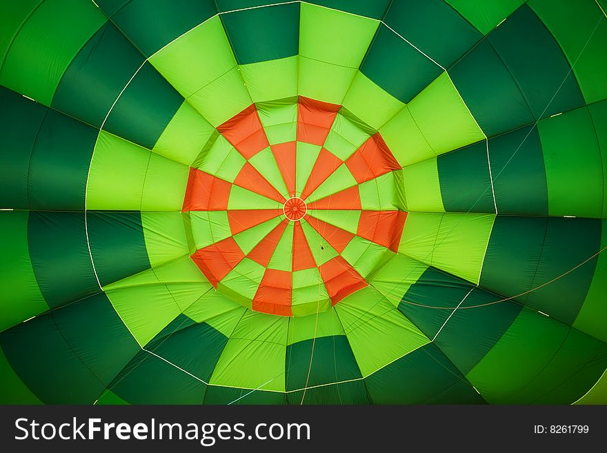Colorful balloon interior creating green and orange background.