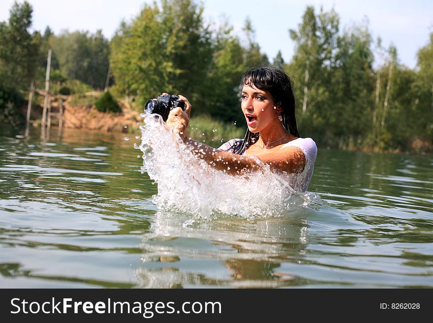 Lovely girl photographer shooting in water. Lovely girl photographer shooting in water