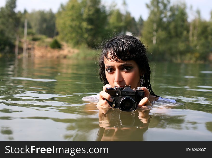 Lovely girl photographer in water