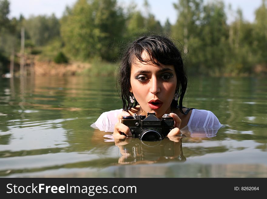 Lovely girl photographer in water