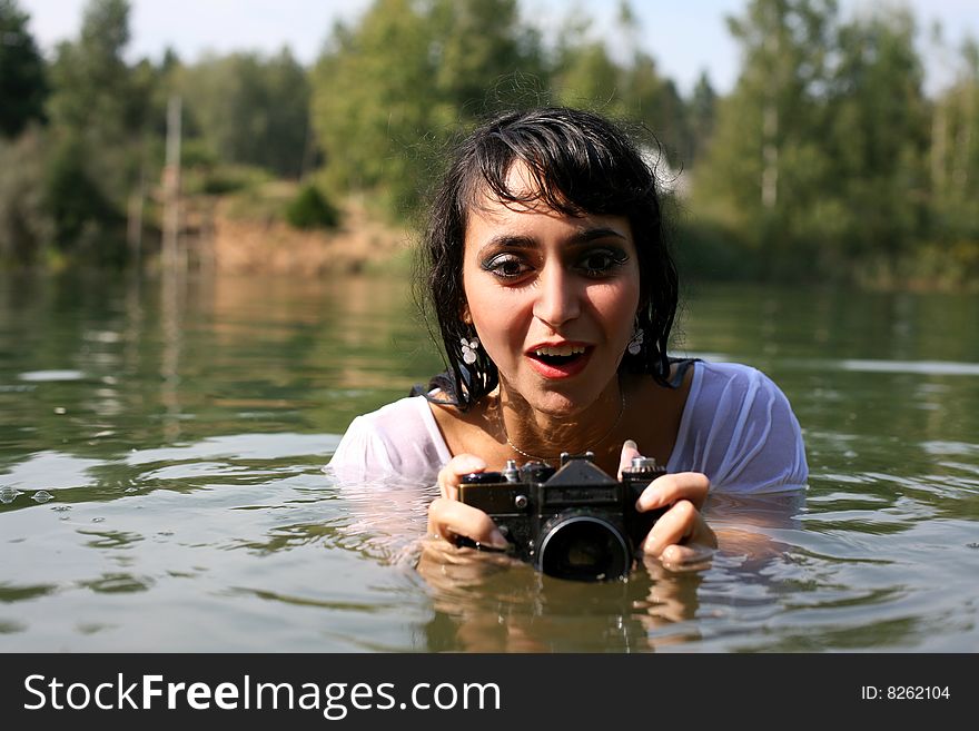 Lovely girl photographer in water