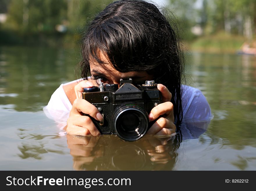Lovely woman hotographer in water in hot summertime. Lovely woman hotographer in water in hot summertime