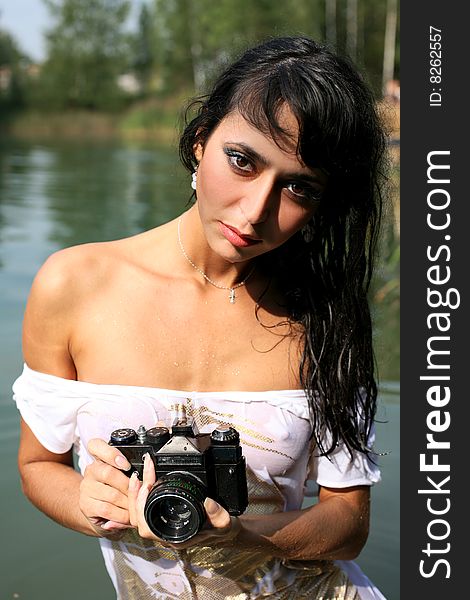 Lovely girl photographer in water