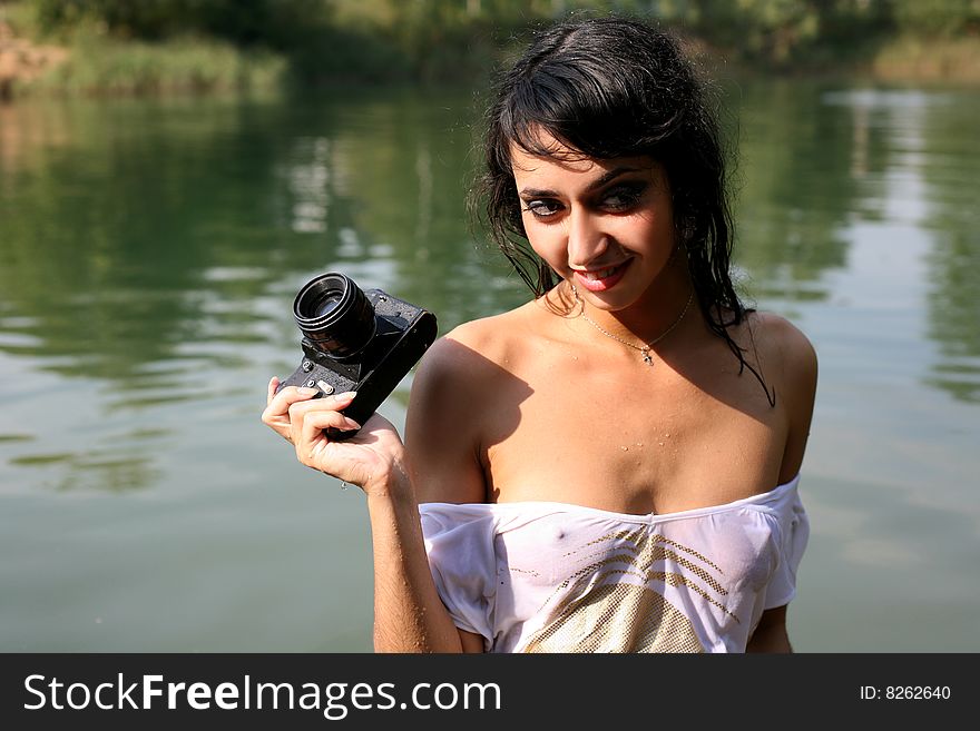 Lovely woman photographer in water