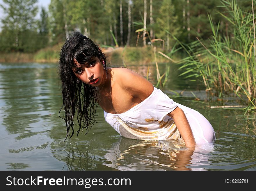 Lovely girl in water in summer