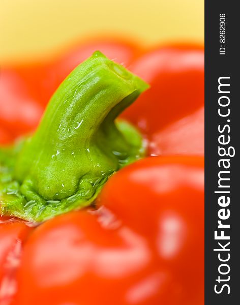 Red bell pepper on a wooden cutting board.