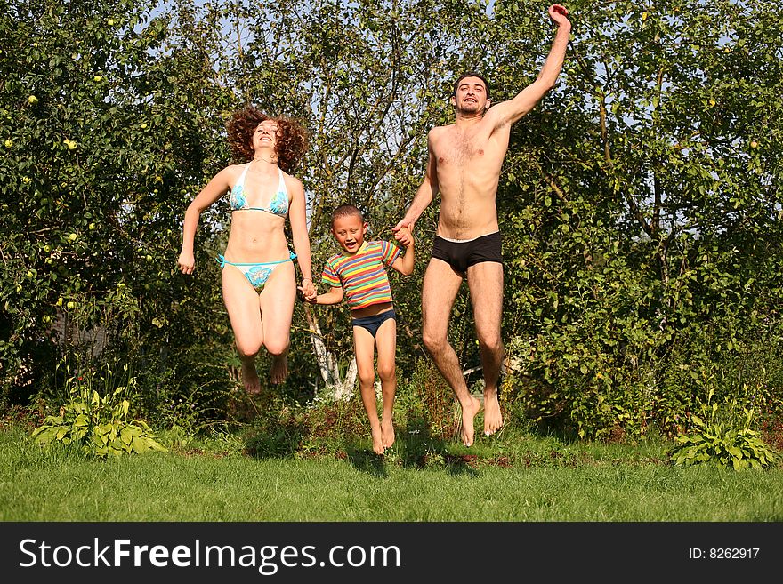 Family together jumping in summertime