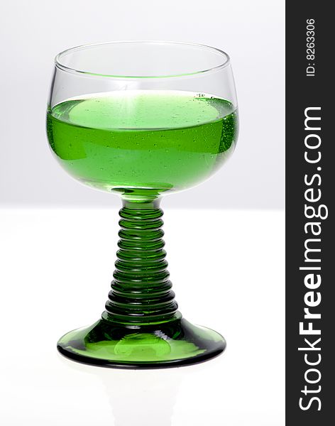 Green cocktail glass on a clean white background