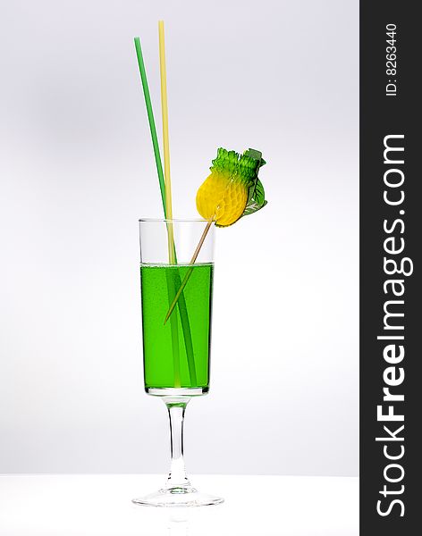 Green cocktail glass on a clean white background