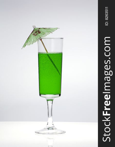 Green cocktail glass on a clean white background