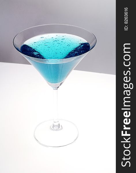 Blue cocktail glass on a clean white background