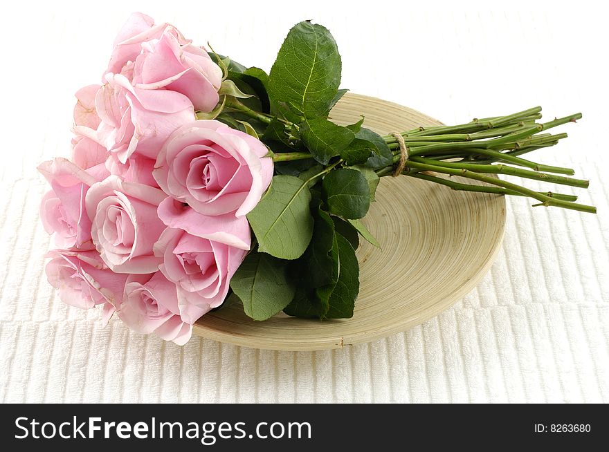 Bouquet of pink roses in wooden bowl
