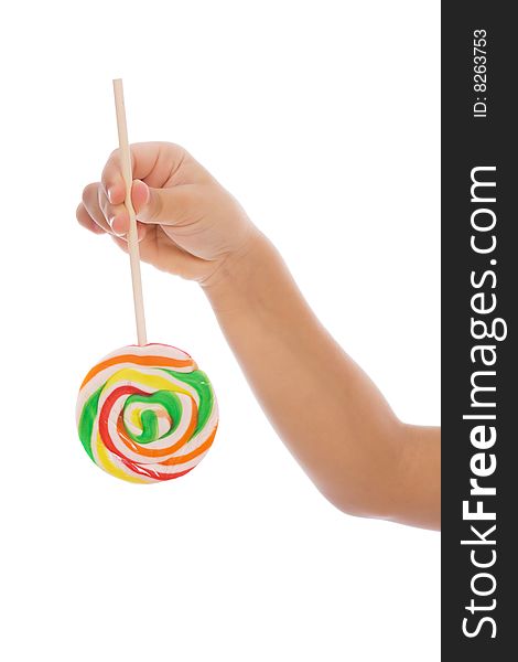 Color lollipop in child hand isolated on white