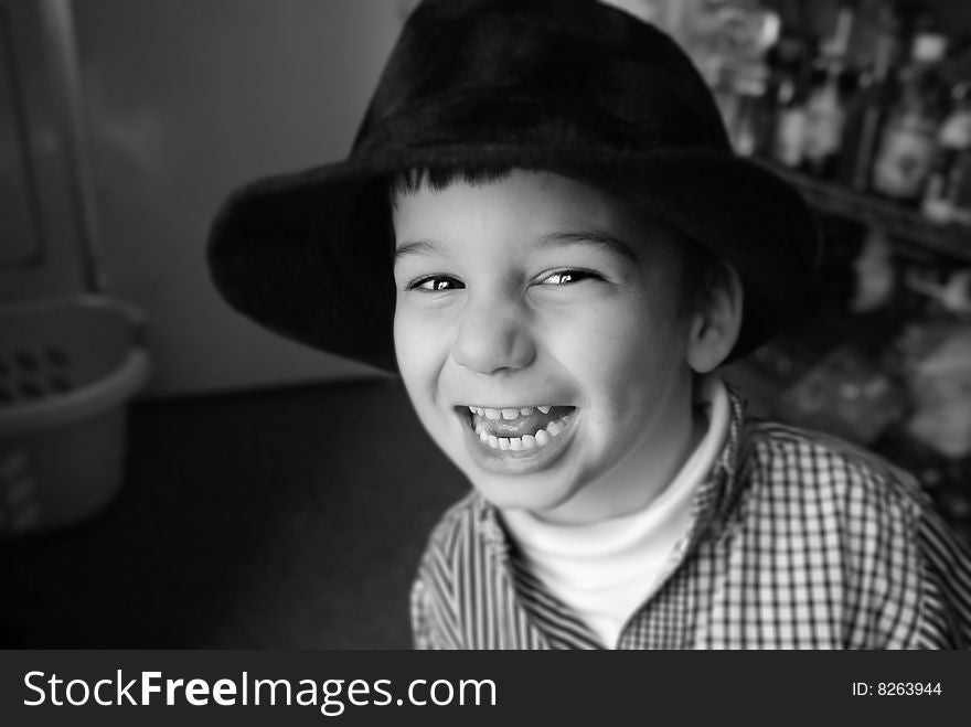 Boy Plays With Hat