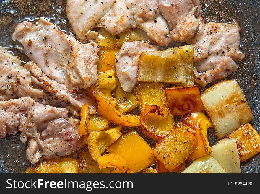 Chicken meat frying with yellow peppers. Chicken meat frying with yellow peppers