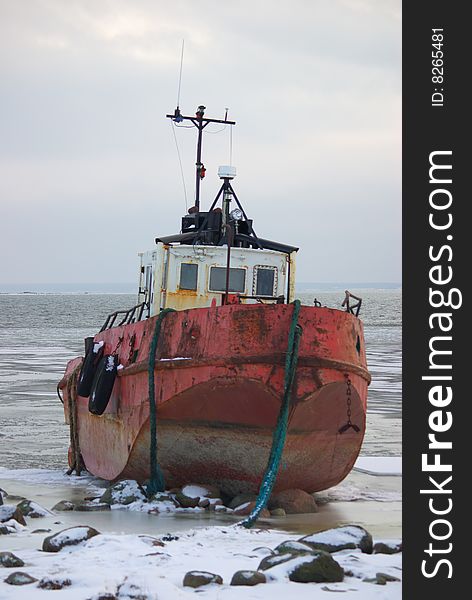 Photo of pilot ship shipwreck that has run ashore on rocks and ice after big storm. This photo is taken near Tiirimetsa in Saaremaa Estonia.