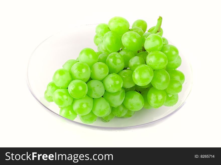 Green grapes in bowl on white background