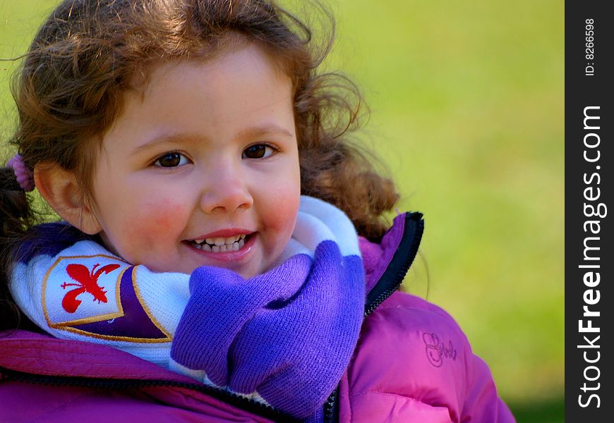 A wonderful image of a little smiling  baby with the Fiorentina soccer team scarf. A wonderful image of a little smiling  baby with the Fiorentina soccer team scarf