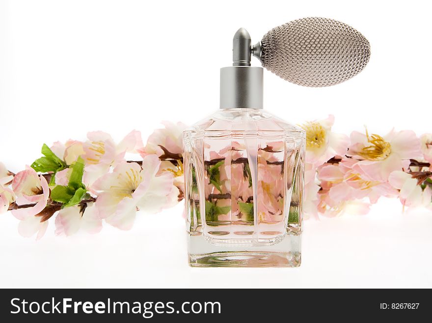 Perfume, pink bottle with cherry blossoms, isolate against a white background