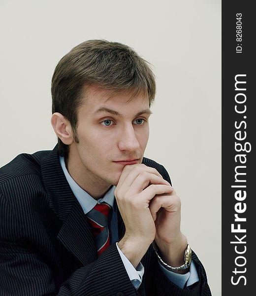 Portrait of a young thoughtful businessman dressed in a business suit and shirt. Portrait of a young thoughtful businessman dressed in a business suit and shirt