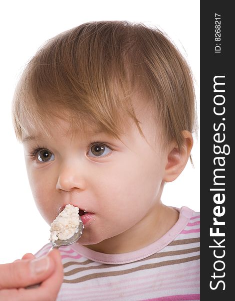 Happy baby girl eating isolated