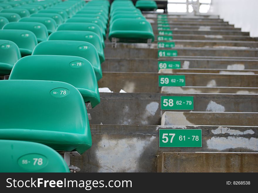 Numbering and aisle of stadium seats with row numbers and seat numbers.