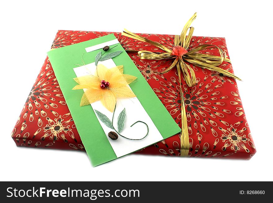 Red gift-box with a gold bow and a card