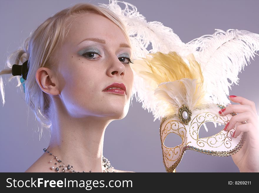 Beautiful young woman with Venetian mask, studio photo. Beautiful young woman with Venetian mask, studio photo