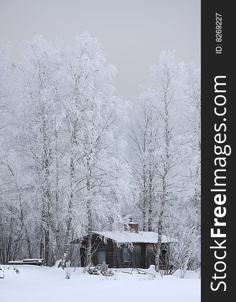 Wooden house in winter in a forest scenery, Finland