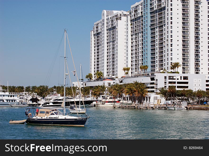 Sailboat anchored at a marina and luxury condo complex in the SoBe section of Miami Beach. Sailboat anchored at a marina and luxury condo complex in the SoBe section of Miami Beach