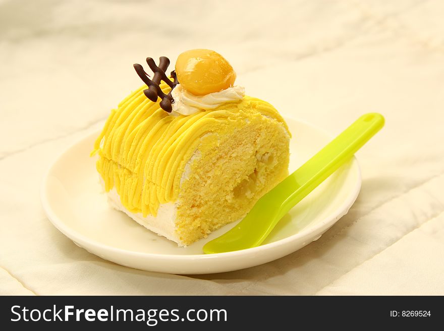 Sliced cake in dish with a spoon,white background . Sliced cake in dish with a spoon,white background