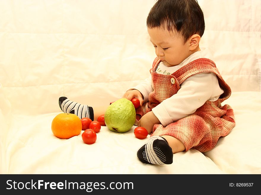 Asia child with Tomato,orange and guava. Asia child with Tomato,orange and guava