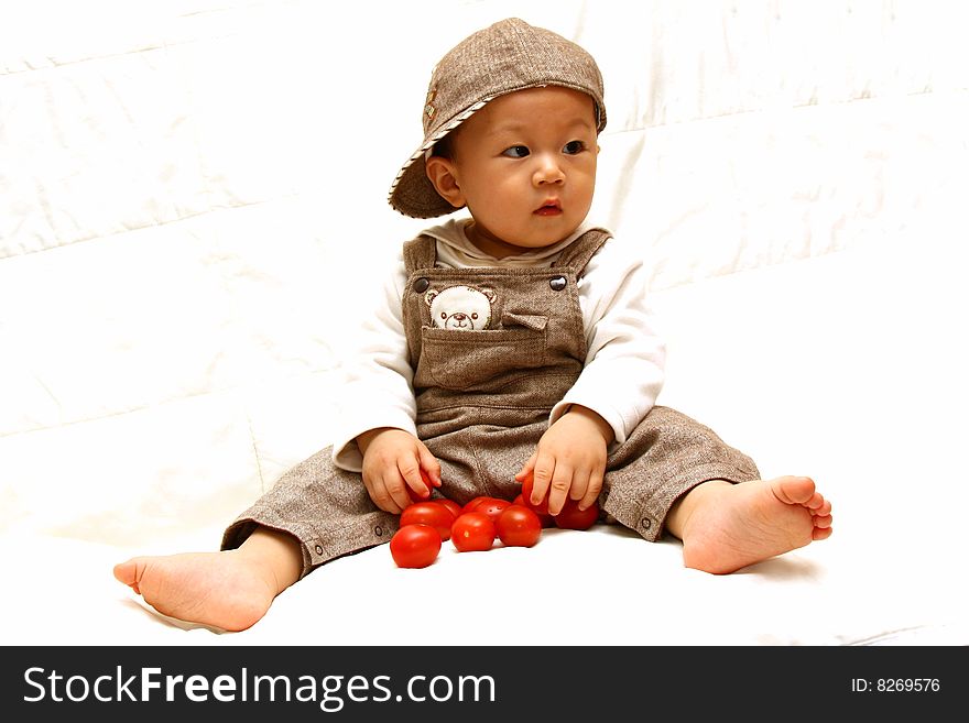 Cute Asia child with Tomato,bare feet. Cute Asia child with Tomato,bare feet