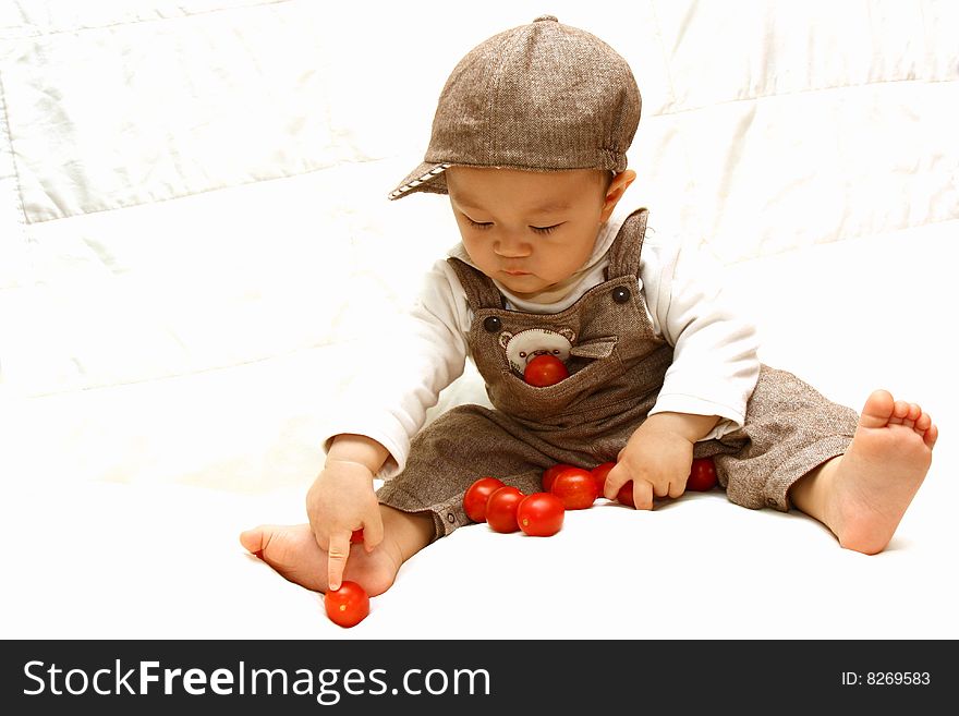 Cute Asia child with Tomato,bare feet. Cute Asia child with Tomato,bare feet