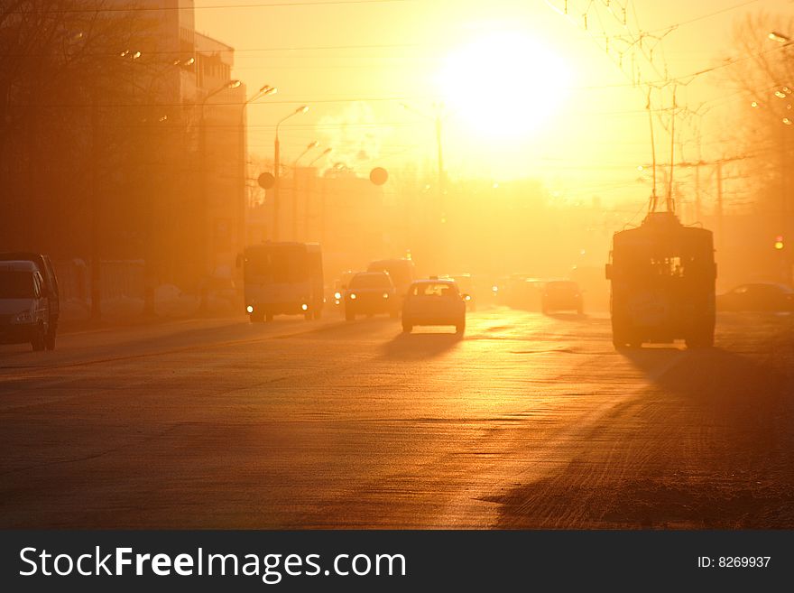 Street lighted up by the rays of a sunset sun. Street lighted up by the rays of a sunset sun