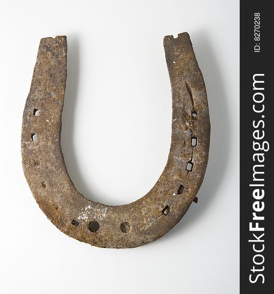 Old rusty horseshoe on white background