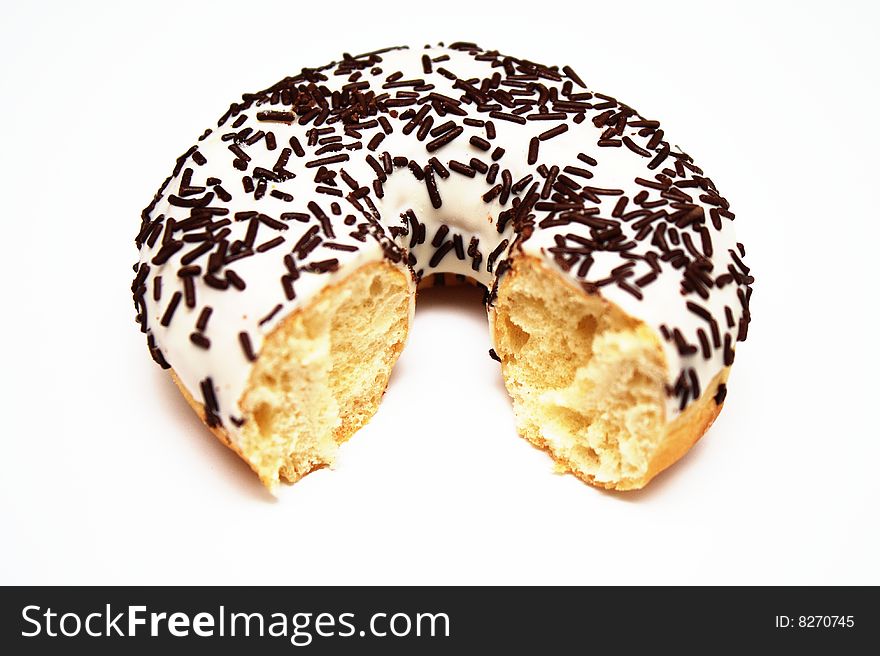 A donut with icing sugar and chocolate sprinkles on it.