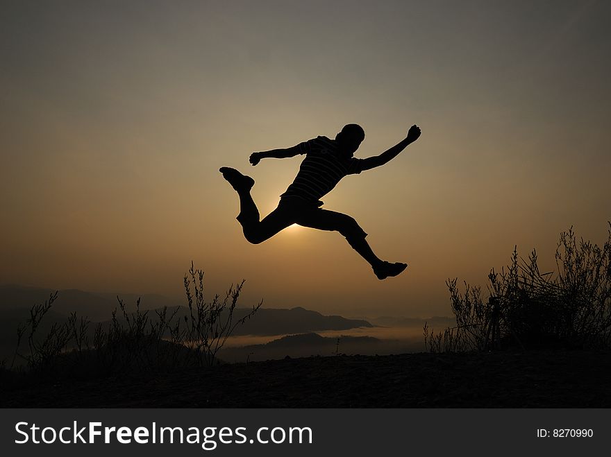 Mans silhouette on the sunset. Mans silhouette on the sunset