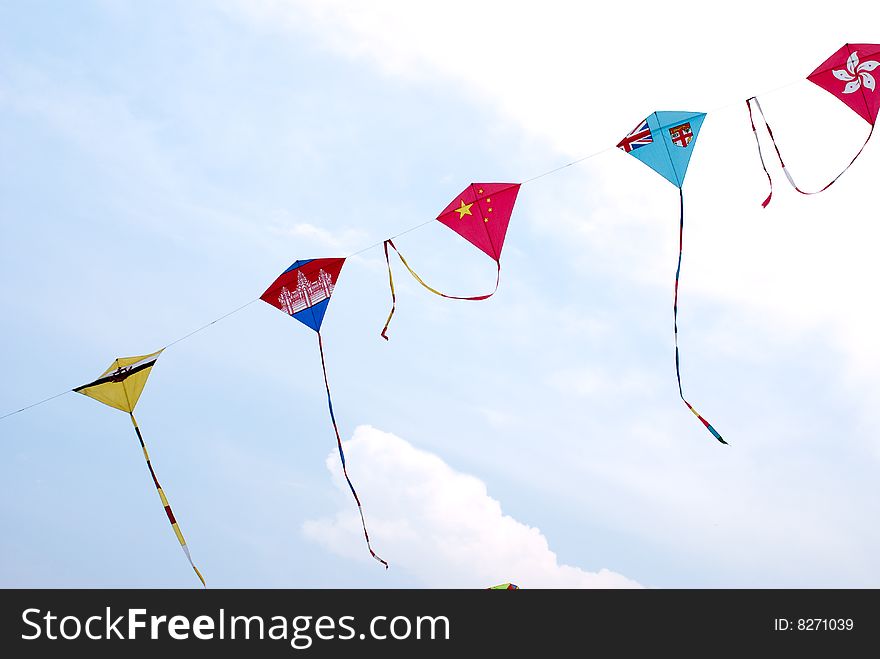 Waving asian countries national flag kites in action