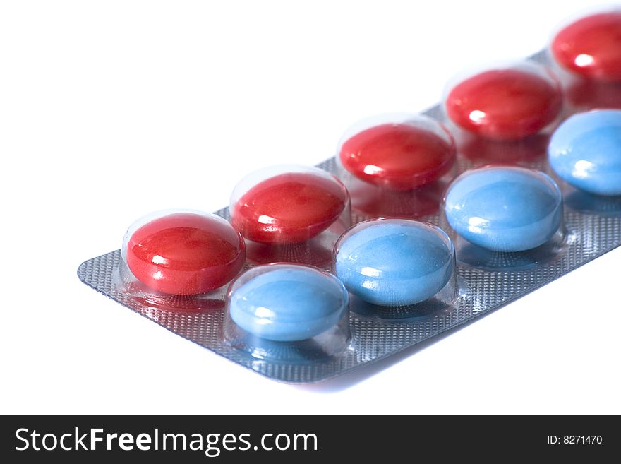 Package with red and blue pills on white background. Package with red and blue pills on white background
