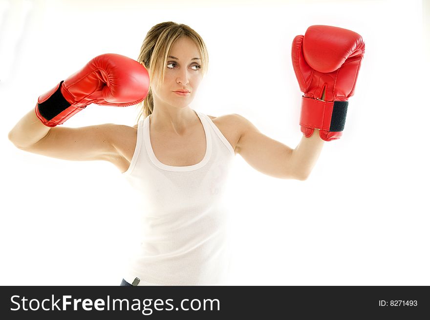 Young kickboxer woman training, isolated