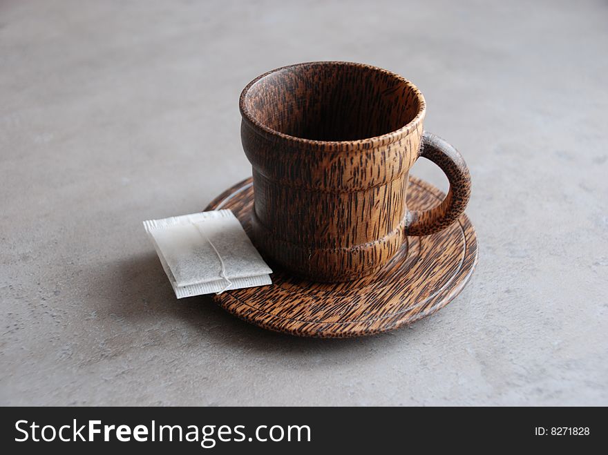 Small cup from wood with tea bag. Small cup from wood with tea bag