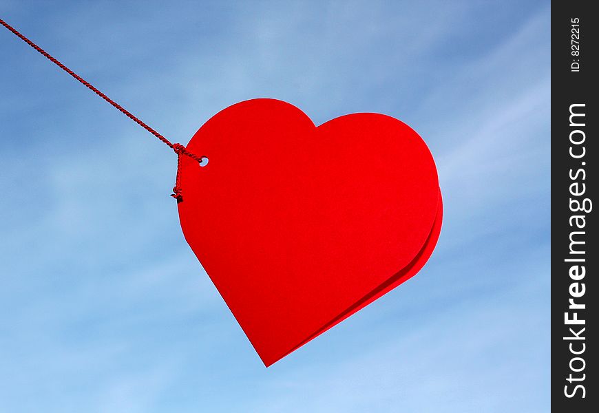 A red heart greeting card in the sky