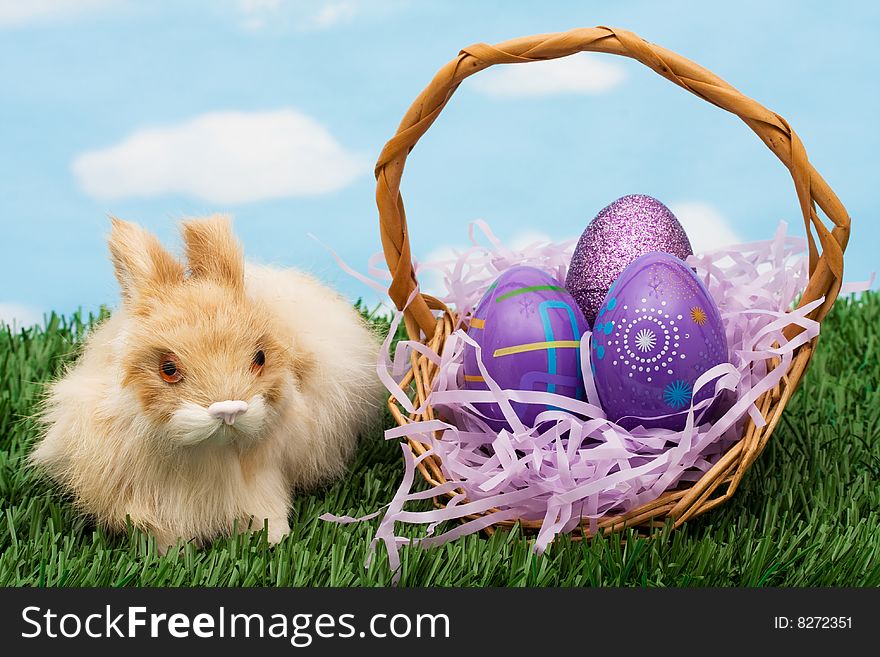 Colourful Easter eggs sitting with a bunny on green grass background, Easter Eggs