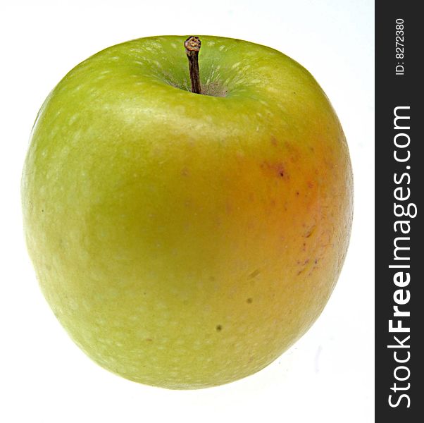 Whole sprinkled green apple with stem.