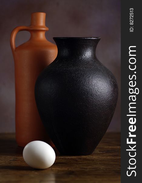 Two vases and an egg composition on a wooden table. Two vases and an egg composition on a wooden table